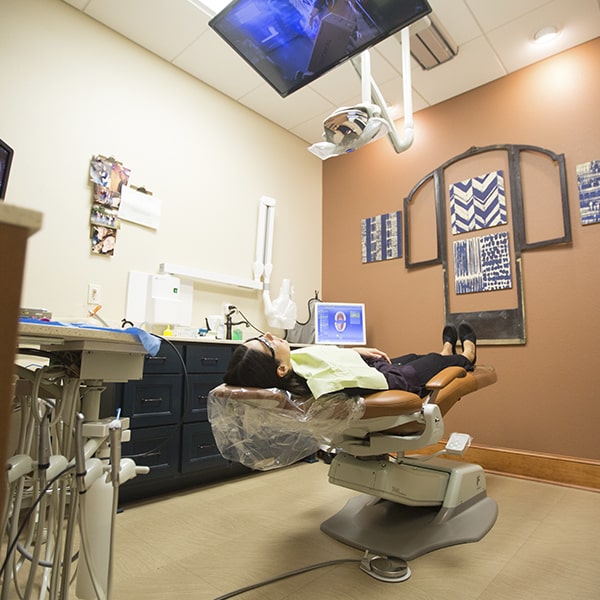Our Bullard office's operating room with a patient lying in the dentist's chair