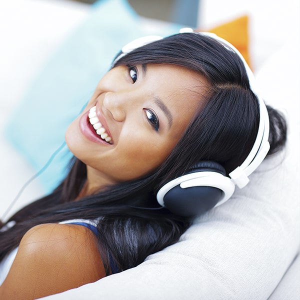 A woman with headphones smiling 